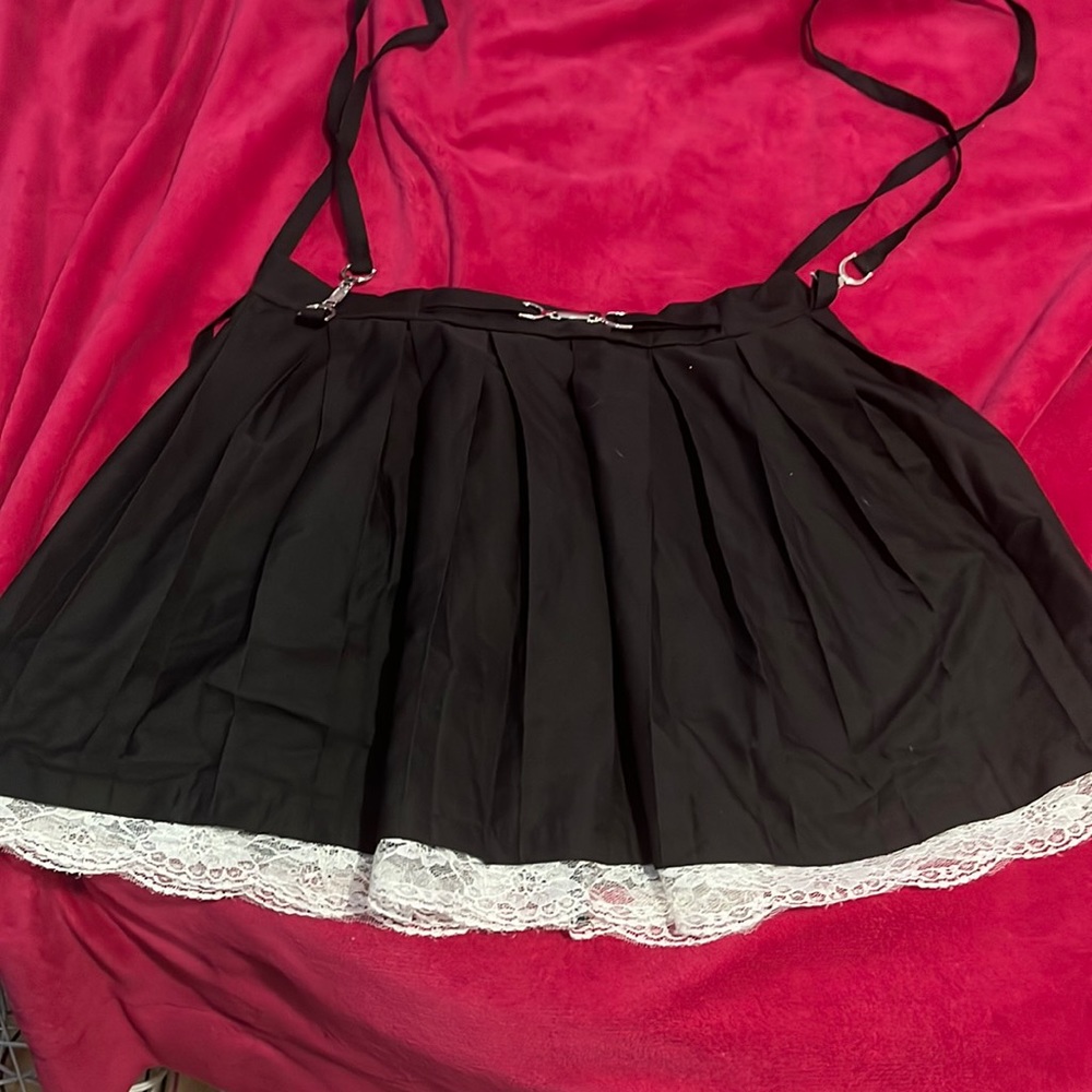 New w/o tags never worn black pleated skirt w/ lace trim. suspenders hang